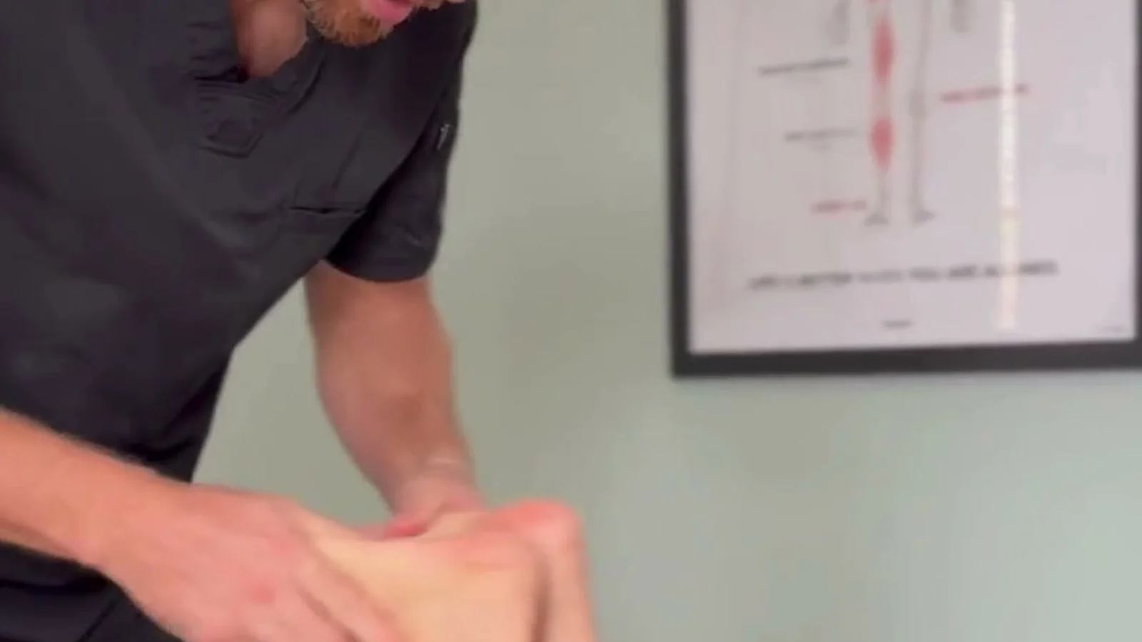 Hands-on treatment of the leg during a visit at Spinal Solutions in St. Augustine